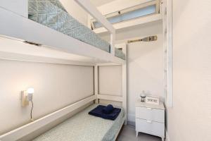 a small bedroom with a bunk bed and a staircase at Tróia Beach House in Carvalhal +17 photos