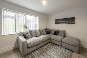 a living room with a couch and a large window at Ridge Grove Lodge "Sleeping 4 guests" 