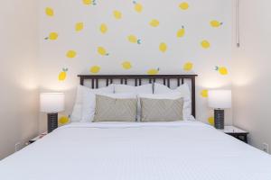 a bedroom with a bed and two lamps at Modern Heritage Studio With Murphy Bed in Victoria