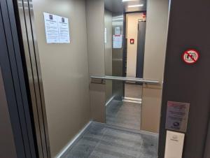 a hallway with a mirror and a walk in elevator at 1 Bedroom Apartment with Garage & Outdoor Area in Kirchberg in Luxembourg