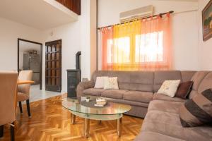 a living room with a couch and a glass table at Poolside Paradise in Srijane