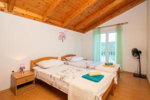 a bedroom with two beds and a window at Poolside Paradise in Srijane +48 photos