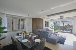 a living room with a table and a couch at Sunrise Villas in Ayia Napa