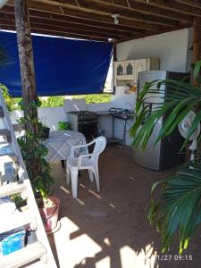 a patio with a table and a chair and a desk at red moon in Santa Marta