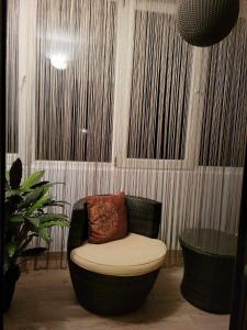 a chair with a pillow on it in a room at Welcome home in Timişoara