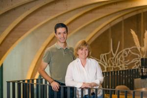 a man and a woman standing on a balcony at Weinhotel Pfeffer & Salz in Gengenbach