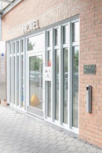 a store front with glass doors on a brick building at Hotel Ambiente in Münster