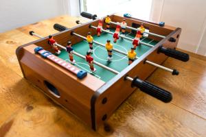 a wooden foosball table with toy men playing a game at Beach in Reach in Eastbourne