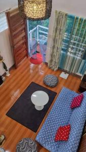 a living room with two mats on a wooden floor at Cozy TinyHouse near SM & Bagasbas Beach w/parking in Daet