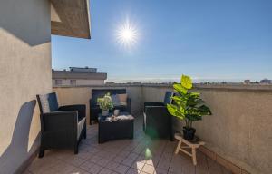 a patio with chairs and a table on a balcony at ComfortHouse in Ravenna in Ravenna