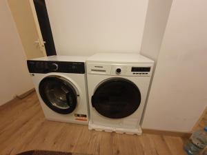 a washer and dryer in a corner of a room at Welcome home in Timişoara