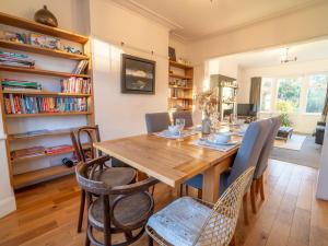a dining room with a wooden table and chairs at Pass the Keys Gorgeous 5 bedroom home in Nottingham
