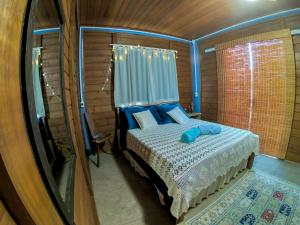 Ένα ή περισσότερα κρεβάτια σε δωμάτιο στο Pousada Bosque das Águas, Imbituba