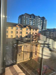 a balcony with a view of a city with buildings at Laid Back In Langford in Langford