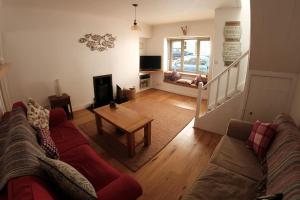 a living room with a couch and a table at Burach in Tobermory