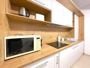 a kitchen with a microwave on a wooden counter at Bella Vista Red Apartment in Braşov