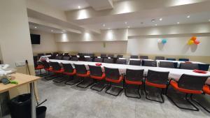 a conference room with a long table and chairs at Hotel le Privilege in La Courneuve