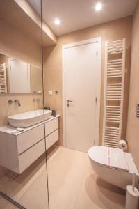a bathroom with a toilet and a sink and a shower at Voula Luxury Apartment in Athens
