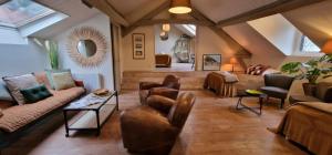 a living room with couches and chairs in a room at La Cour Sainte Catherine demeure de charme in Honfleur