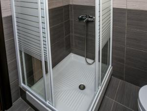 a shower with a glass door in a bathroom at Villa Oliva in Astris +55 photos