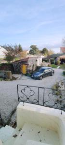 a blue car parked in a parking lot at Studio Propre et Cosy in Le Mesnil-en-Vallée