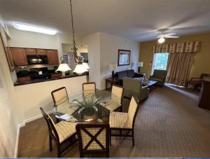 a living room with a table and chairs and a kitchen at Best Disney Resort Condo Orlando in Orlando