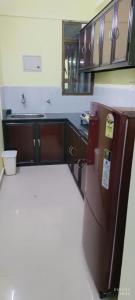 a kitchen with a brown refrigerator in a room at 1 BHK Flat in Kochi 904 in Cochin