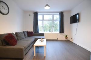 a living room with a couch and a table at Contemporary 3 Bedroom Flat in Fife