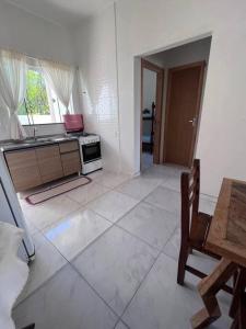 a kitchen with a sink and a stove top oven at Casa praia em Penha - disponível in Penha
