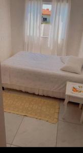 a bed in a room with a window at Casa praia em Penha - disponível in Penha