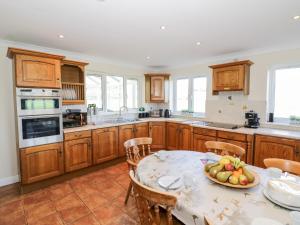a kitchen with a table with a bowl of fruit on it at Tixall Manor Farm in Stafford