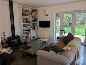 a living room with two couches and a coffee table at Cosy Garden View Room in East Grinstead