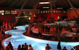 a group of people standing around a swimming pool in a building at Superbe villa avec piscine proche de belfort in Meroux +61 photos