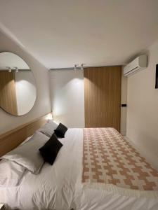a bedroom with a large white bed with a mirror at Casabell 3 Caminito del Rey in Valle de Abdalagís