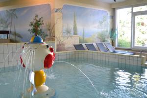 a swimming pool with a fish in the water at Ferienvermietung Sporer in Sankt Englmar