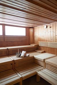 an empty sauna with wooden benches and a window at Ferienvermietung Sporer in Sankt Englmar