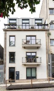 an apartment building with balconies on the side of it at Wood Premium Downtown Apartment by DA'HOME in Porto