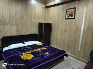 a bedroom with a bed with flowers on it at Silver Dew Resorts and Restaurant in Dhanaulti