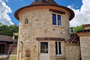 a large stone building with a round top at Domaine de la Tour de Pérès in Ayguetinte