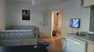 a living room with a couch and a tv at Apartments Foco in Sarajevo