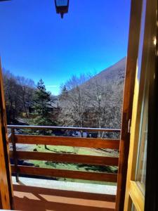 a door to a balcony with a view of a mountain at A casa di Giulia in Filettino
