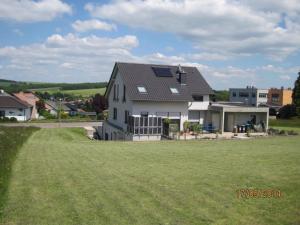 a house with a large grassy field in front of it at Haus Perkow 