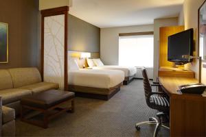 a hotel room with two beds and a television at Hyatt Place Sacramento Roseville in Roseville