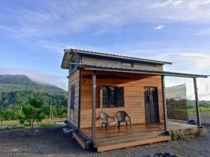a tiny house with two chairs on top of it at Wawowow in Tomohon