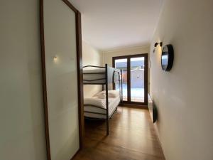 a mirror in a room with a bunk bed at Prat de Baix Bordas d'Envalira in Bordes d´Envalira