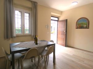 comedor con mesa, sillas y puerta en SCAPPO IN UMBRIA, Apartments, en Narni Scalo