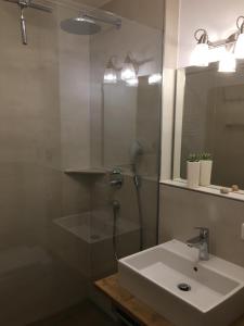 a bathroom with a sink and a shower and a mirror at Almstube in Bad Hindelang