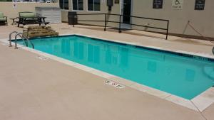 a swimming pool with blue water in a building at Comfort Inn & Suites Lakeside in Eagle Pass