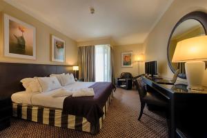 a hotel room with a bed and a desk at Hotel Solverde Spa and Wellness Center in Vila Nova de Gaia