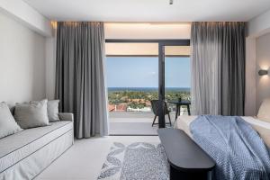 a hotel room with a bed and a large window at Nuovo Luxury Suites in Daratso